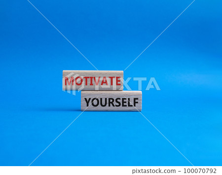 Motivation symbol. Concept words Motivate yourself on wooden blocks. Beautiful blue background. Business and Motivate yourself concept. Copy space. 100070792