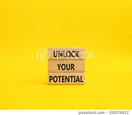 Unlock your Potential symbol. Wooden blocks with words Unlock your Potential. Beautiful yellow background. Business and Unlock your Potential concept. Copy space. 100070812