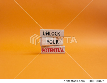 Unlock your Potential symbol. Wooden blocks with words Unlock your Potential. Beautiful orange background. Business and Unlock your Potential concept. Copy space. 100070874