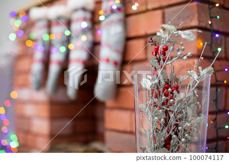 Brick fireplace and glass vase with decorations. Brick fireplace and glass vase with decorations. 100074117