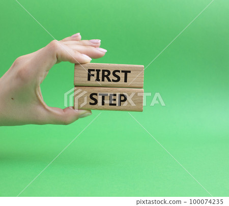 First step symbol. Wooden blocks with words First step. Beautiful green background. Businessman hand. Business and First step concept. Copy space. First step symbol. Wooden blocks with words First step. Beautiful green background. Businessman hand. Business and First step concept. Copy space. 100074235