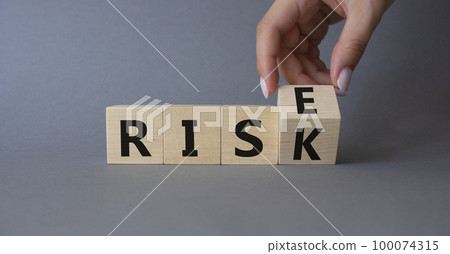 Rise vs Risk symbol. Hand turns cubes and changes the word Risk to Rise. Beautiful grey background. Businessman hand. Business and Rise vs Risk concept. Copy space Rise vs Risk symbol. Hand turns cubes and changes the word Risk to Rise. Beautiful grey background. Businessman hand. Business and Rise vs Risk concept. Copy space 100074315