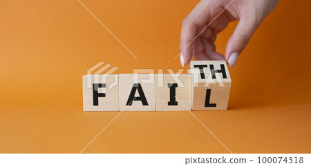 Faith vs Fail symbol. Businessman hand Turnes cube and changes word Fail to Faith. Beautiful orange background. Business and Faith vs Fail concept. Copy space 100074318