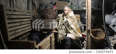 A woman hides in a cellar from shelling 100074955