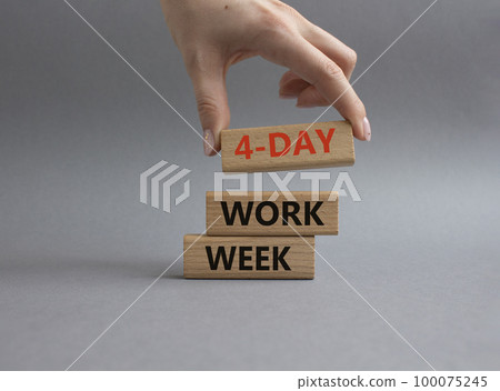 4-day work week symbol. Concept words 4-day work week on wooden blocks. Beautiful grey background. Businessman hand. Business and 4-day work week concept. Copy space 100075245