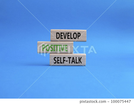 Develop positive self-talk symbol. Concept words Develop positive self-talk on wooden blocks. Beautiful blue background. Business and Develop positive self-talk concept. Copy space 100075447