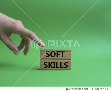 Soft skills symbol. Wooden blocks with words Soft skills. Beautiful green background. Businessman hand. Business and Soft skills concept. Copy space. 100075511