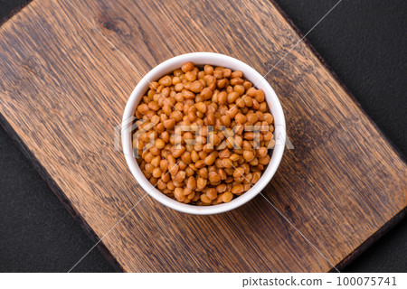 Delicious healthy canned lentils in a ceramic ribbed white bowl 100075741