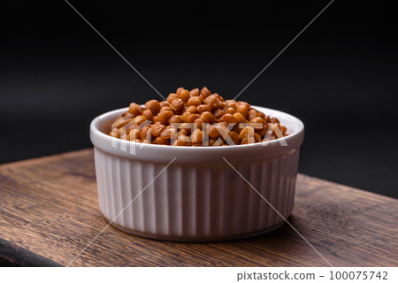 Delicious healthy canned lentils in a ceramic ribbed white bowl Delicious healthy canned lentils in a ceramic ribbed white bowl 100075742