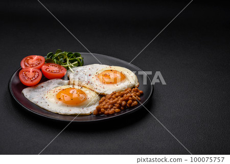 Delicious hearty breakfast consisting of two fried eggs, canned lentils and microgreens Delicious hearty breakfast consisting of two fried eggs, canned lentils and microgreens 100075757