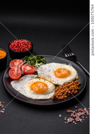 Delicious hearty breakfast consisting of two fried eggs, canned lentils and microgreens 100075764