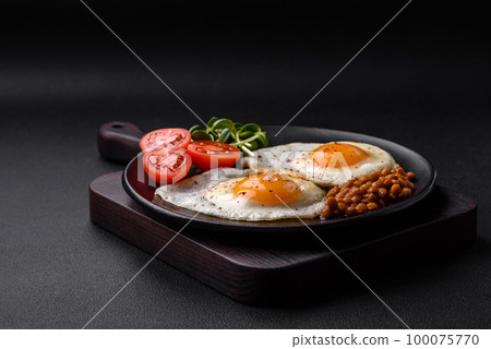 Delicious hearty breakfast consisting of two fried eggs, canned lentils and microgreens Delicious hearty breakfast consisting of two fried eggs, canned lentils and microgreens 100075770