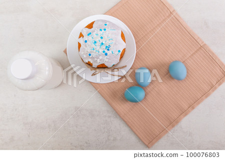 Easter russian cake, colorful eggs on a napkin and bottle of milk, on light table. Easter russian cake, colorful eggs on a napkin and bottle of milk, on light table. 100076803