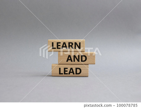 Learn and lead symbol. Concept words Learn and lead on wooden blocks. Beautiful grey background. Business and Learn and lead concept. Copy space. 100078785