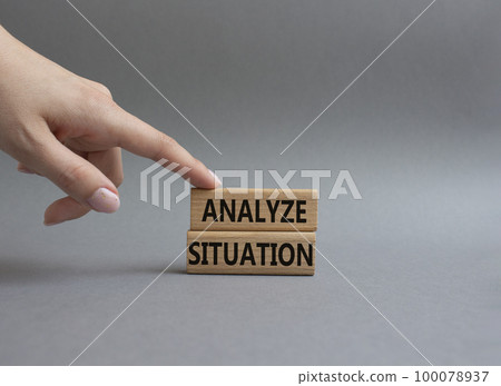 Analyze situation symbol. Wooden blocks with words Analyze situation. Beautiful grey background. Businessman hand. Business and Analyze situation concept. Copy space. 100078937