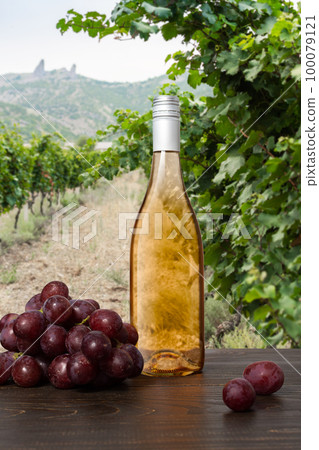 Bottle of rose wine with grapes Bottle of rose wine with grapes 100079121