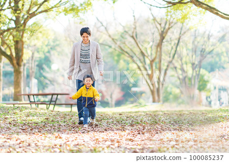 Dad and boy playing in the park Dad and boy playing in the park 100085237