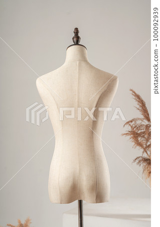 Vintage mannequin without hands on a light studio background Vintage mannequin without hands on a light studio background 100092939