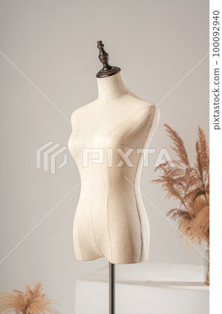 Vintage mannequin without hands on a light studio background Vintage mannequin without hands on a light studio background 100092940