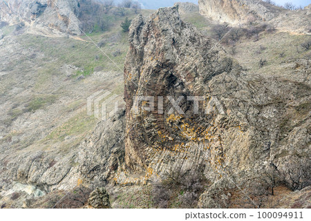 Devil's fireplace rock and bizarre rocks in Dead city. Khoba-Tele Ridge of Karadag Reserve in spring. Crimea 100094911