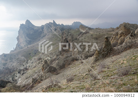 Bizarre rocks in Dead city. Khoba-Tele Ridge of Karadag Reserve in spring. Crimea 100094912