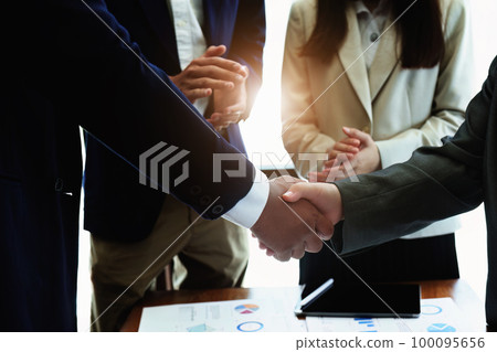 Asian entrepreneurs handshakes to congratulate the agreement between the two companies to enhance investment and financial strength. deal concept. 100095656