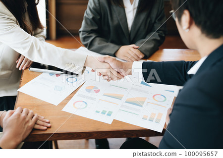 Asian entrepreneurs handshakes to congratulate the agreement between the two companies to enhance investment and financial strength. deal concept. 100095657