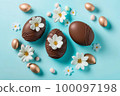 Easter composition with chocolate and gold eggs 100097198