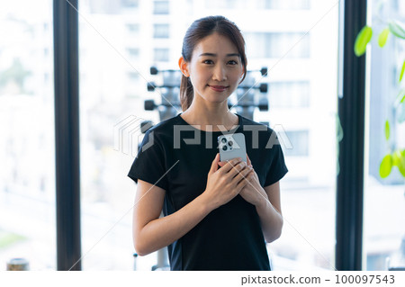 gym instructor with smartphone gym instructor with smartphone 100097543