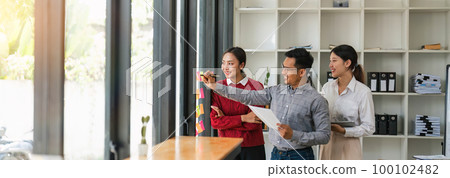 Business people meeting at office and use sticky notes to share idea. Brainstorming concept. Sticky note on glass wall 100102482