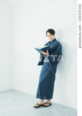 man in yukata reading man in yukata reading 100105162