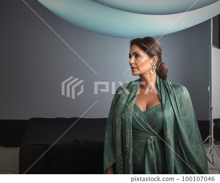 Disappointed and sad looking photo model with a fashionable green dress in the photo studio in front of a black bed, made with generative AI 100107046