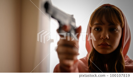 A scene like a movie of a woman holding a gun 100107819