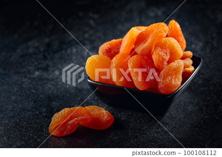 Dried apricots in a small ceramic dish. Dried apricots in a small ceramic dish. 100108112