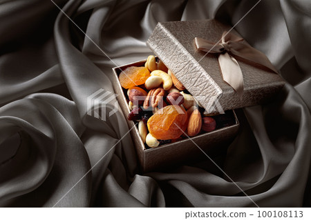 Dried fruits and nuts in a gift box. 100108113