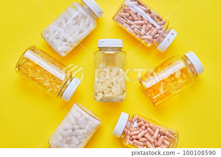 Many supplements over yellow background Many supplements over yellow background 100108590