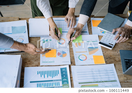 Businessmen team or financial data analysts working with tablets and laptop computers and data graphs together. Plan to analyzing projects in the office. 100111449