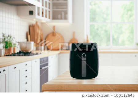 Air fryer machine cooking potato fried in kitchen. Lifestyle of new normal cooking.. Air fryer machine cooking potato fried in kitchen. Lifestyle of new normal cooking.. 100112645
