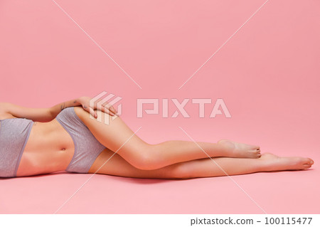 Beautiful slender female legs over pink background. Concept of beauty, body and skin care, healthy lifestyle, fashion, depilation, cosmetics, spa. Beautiful slender female legs over pink background. Concept of beauty, body and skin care, healthy lifestyle, fashion, depilation, cosmetics, spa. 100115477