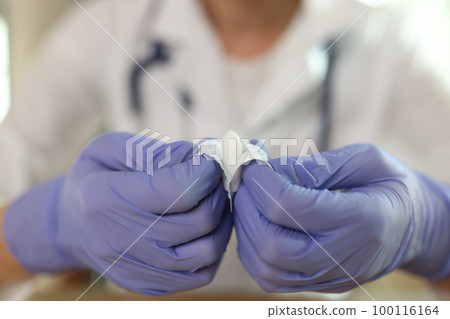 Gynecologist shows suppositories for anal or vaginal use close up. 100116164