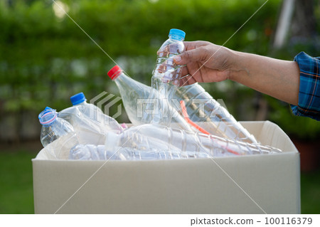 Woman holding plastic bottles garbage in box to reuse recycle for good environment. Woman holding plastic bottles garbage in box to reuse recycle for good environment. 100116379