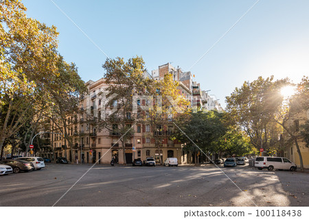 View of front entrance of a six-storey luxury building in the center of a European city on sunny warm autumn day next to a cozy urban area with parking lots. Concept of a quiet prosperous area View of front entrance of a six-storey luxury building in the center of a European city on sunny warm autumn day next to a cozy urban area with parking lots. Concept of a quiet prosperous area 100118438