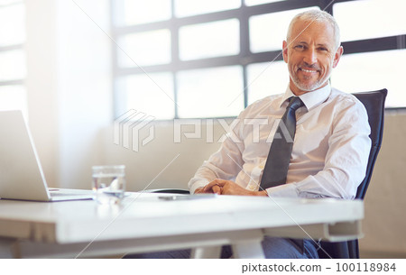 Technology keeps me connected to my competitors. Portrait of a mature businessman sitting at his desk in an office. 100118984