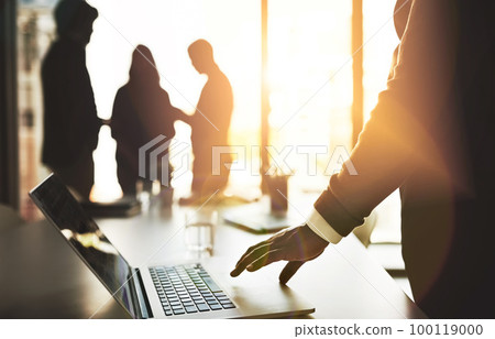 Manager with laptop, team leader and boss getting ready to lead group meeting, planning and innovation with tech. Silhouette of colleagues waiting for discussion to start or begin in office boardroom 100119000