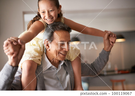 Grandpa is so fun. Shot of a grandfather giving his little granddaughter a piggy back. 100119067