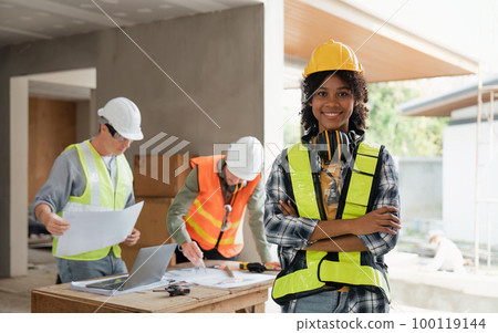 portrait female engineer project manager with construction gear and project blueprint Architecture team building plans 100119144