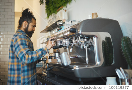 Cafe, startup and service with a man barista behind the counter to prepare a drink. Coffee shop, kitchen and waiter with a male working in a restaurant as an entrepreneur or small business owner Cafe, startup and service with a man barista behind the counter to prepare a drink. Coffee shop, kitchen and waiter with a male working in a restaurant as an entrepreneur or small business owner 100119277