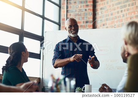 Senior businessman doing a presentation talking or explaining business KPI report, workflow management and strategy for teamwork interaction. Successful corporate manager at economic forecast meeting 100119527