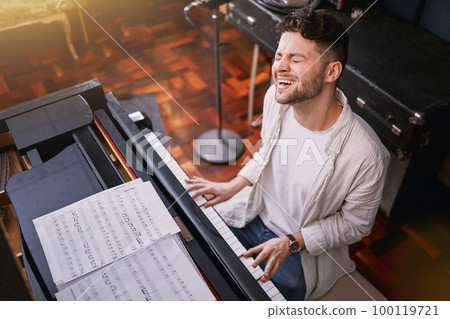 Top view, piano and man singing, creative and training for performance, show or talent. Male artist with skills, recording studio or singer with keyboard, vocal practice or playing musical instrument 100119721