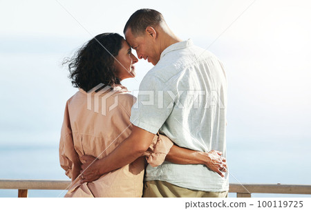 Love, back and senior couple by beach, hug and enjoying quality time on holiday or vacation. Romance, care and retired happy man and woman hugging, embrace or cuddle while having fun by seashore. 100119725